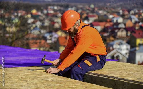 Construction Industry and Waterproofing. roofer working on roof structure of building on construction site. roofer wear safety uniform inspection. Roofer working. Roofer working tool © be free
