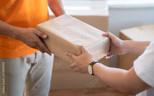 Young man receives a package from the courier's hand.