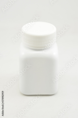 White plastic bottle container with screw cap
