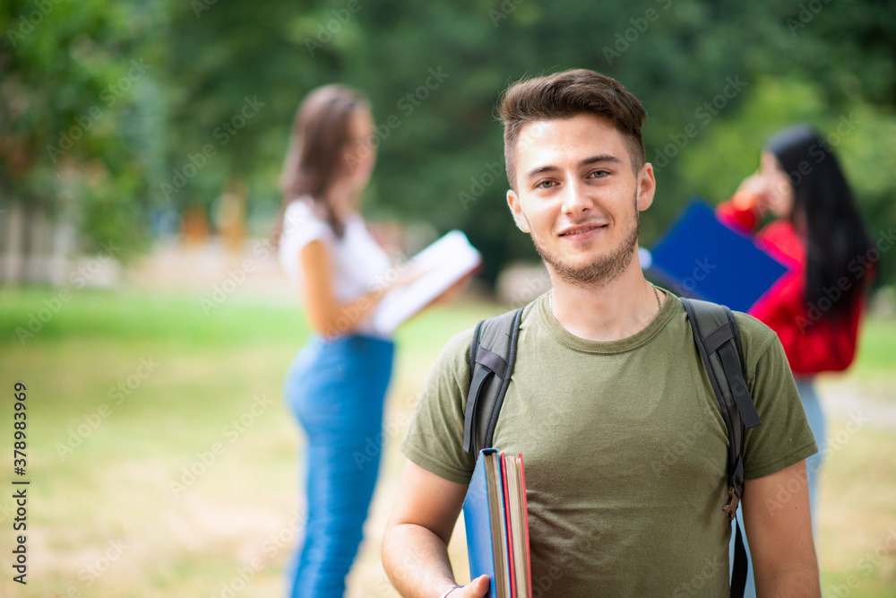 Young student in front of a group of friends Young student in front of a group of friends