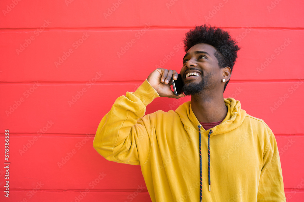 Afro man talking on the phone. Afro man talking on the phone.