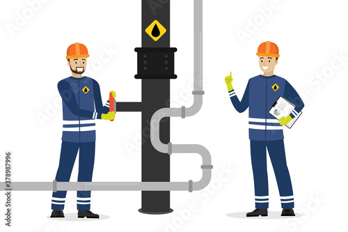 Happy oilman turns a pipeline valve. Engineer checks and controlled. Oil industry, workers in special clothing and helmet. Work safety.