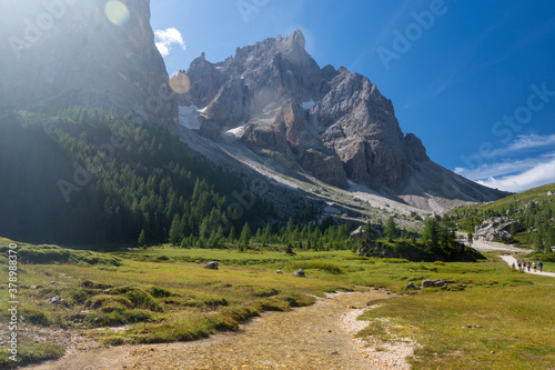 Small river streams in the middle of Val Venegia, surrounded by high dolomite peaks of Latemar mountain group. Trentino, Italy photo