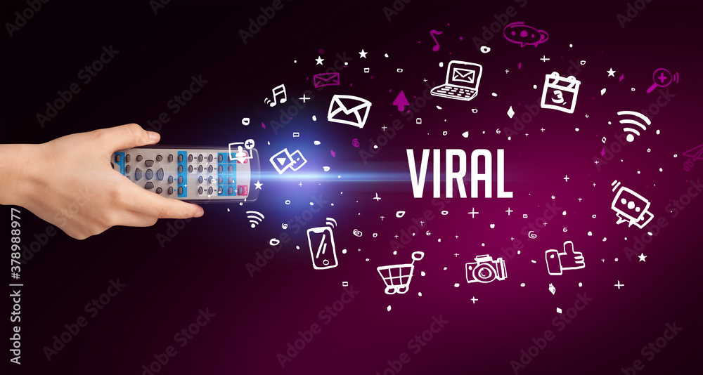 Fototapeta premium hand holding wireless peripheral with VIRAL inscription, social media concept