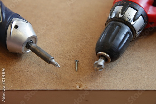 Screw, countersink and electric screwdriver, countersunk hole forging in DIY woodworking