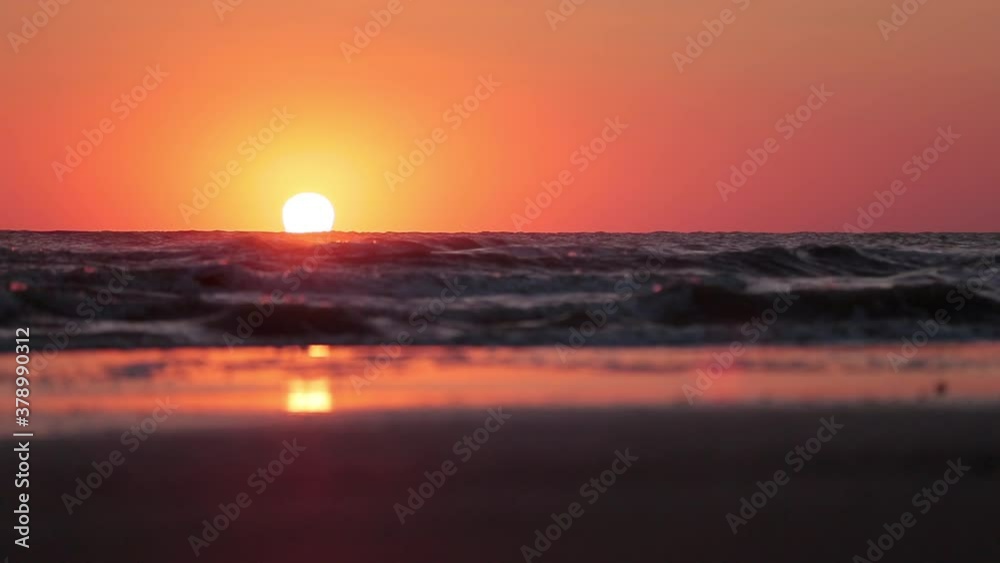 Sea waves at dawn under a cloudy summer sky Sea waves at dawn under a cloudy summer sky