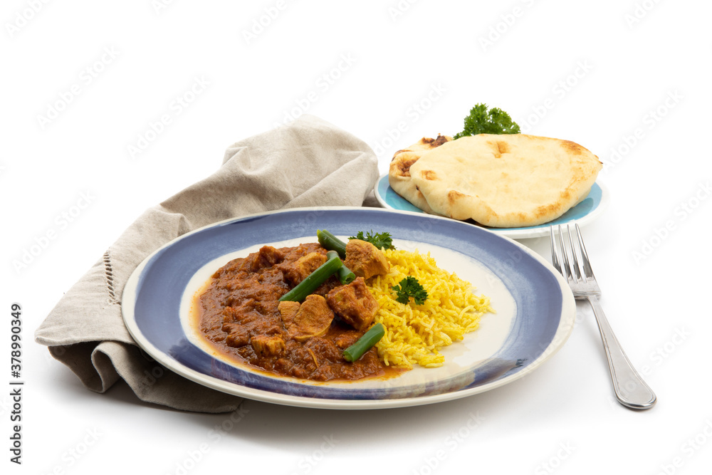 a blue plate of Indian buttered chicken and curry rice with a plate of naan bread on a white background