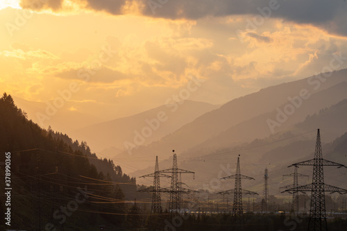 Sunset in the austrian alps with power stations infront