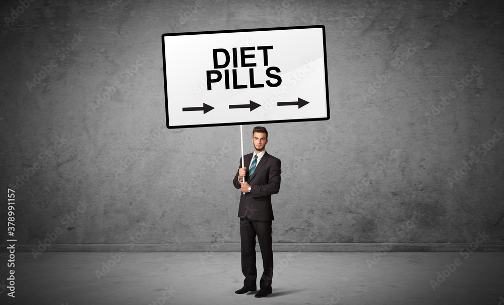 business person holding a traffic sign with DIET PILLS inscription, new idea concept business person holding a traffic sign with DIET PILLS inscription, new idea concept