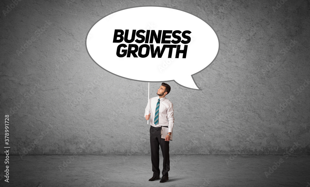 Young business person in casual holding road sign with BUSINESS GROWTH inscription, new business idea concept Young business person in casual holding road sign with BUSINESS GROWTH inscription, new business idea concept