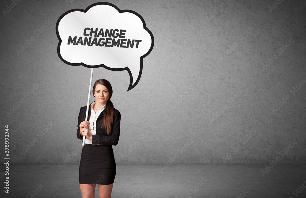 Young business person in casual holding road sign with CHANGE MANAGEMENT inscription, new business idea concept Young business person in casual holding road sign with CHANGE MANAGEMENT inscription, new business idea concept