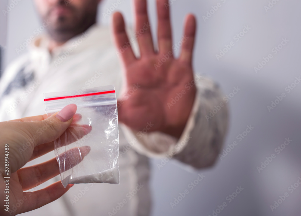 Man hand holds a plastic bag or bag with cocaine