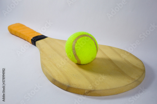 Beach tennis racket and ball with white background photo