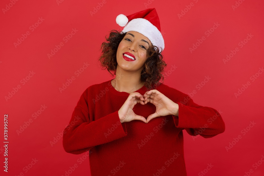 Beautiful caucasian woman over isolated background smiling in love showing heart symbol and shape with hands. Romantic concept.