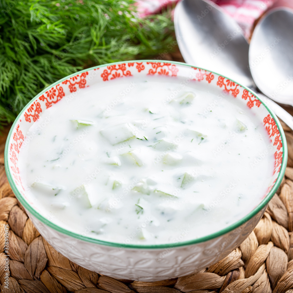 Tzatziki Sauce, Turkish Cacik Yogurt with Cucumber Slices and Olive Oil in ceramic bowl. Tzatziki Sauce, Turkish Cacik Yogurt with Cucumber Slices and Olive Oil in ceramic bowl.
