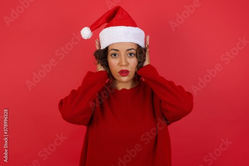 Woman plugging ears with hands does not wanting to listen hard rock or loud music. European Young female ignoring noise or din covering her ears with hands avoiding loud sounds at street.