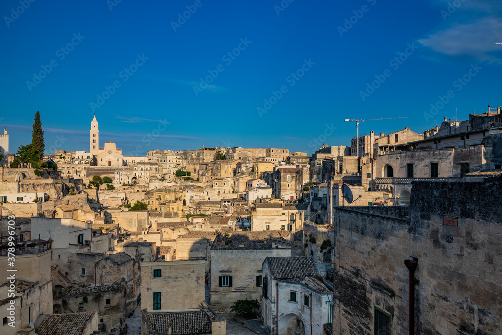 Matera, Basilicata, Italy - Panoramic view of the Sassi of Matera, Caveoso. The ancient houses of stone and brick, carved into the rock. The cathedral in the background.
