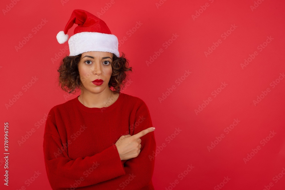 Excited surprised fashionable girl points happily aside on copy space of gray background for your fashion clothing advertising information or promotional text. Excited surprised fashionable girl points happily aside on copy space of gray background for your fashion clothing advertising information or promotional text.