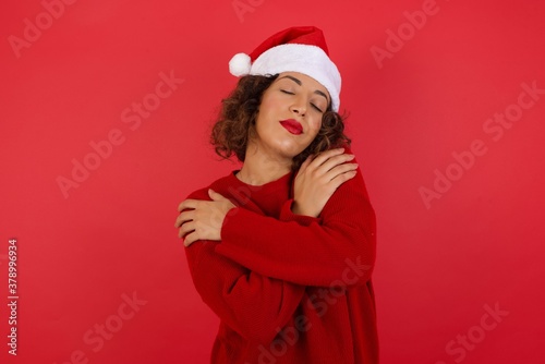 Portrait of nice-looking sweet lovable attractive winsome fascinating well-groomed lovely calm peaceful cheery girl hugging herself isolated over bright background