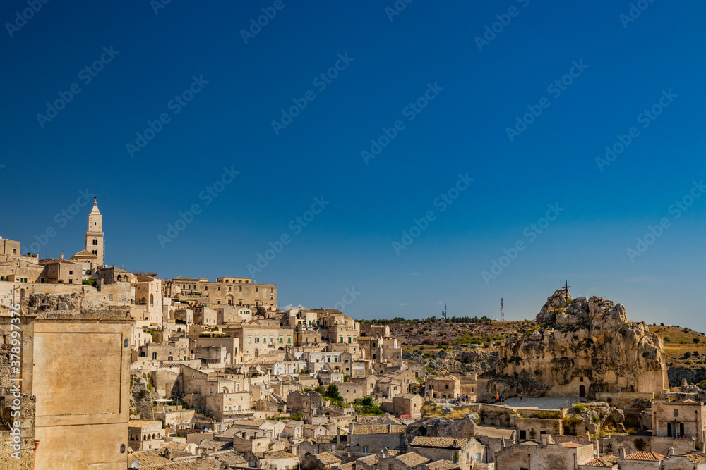 Matera, Basilicata, Italy - Panoramic view from the top of the Sassi of Matera, Barisano and Caveoso. The ancient houses of stone and brick, carved into the rock. The ravine in the background.