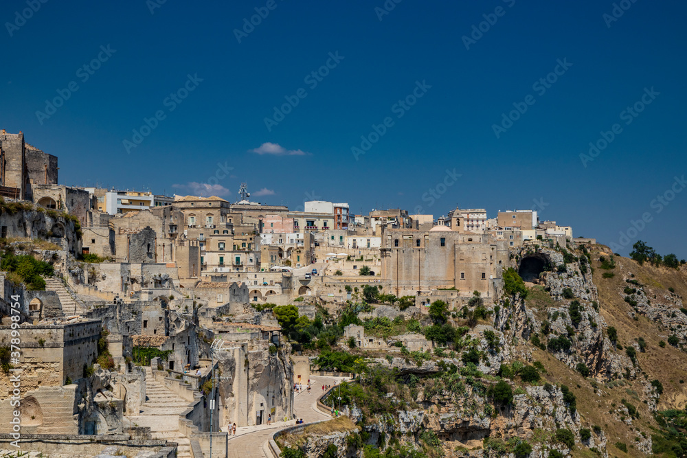Matera, Basilicata, Italy - Panoramic view from the top of the Sassi of Matera, Barisano. The ancient houses of stone and brick, carved into the rock. The church of Sant'Agostino.
