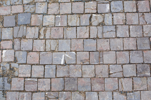 Texture of old broken stone paving stones