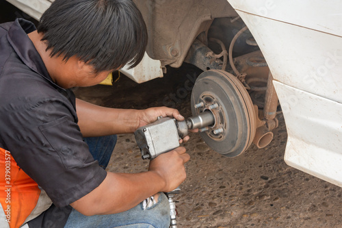 The mechanic repair drum brake of car