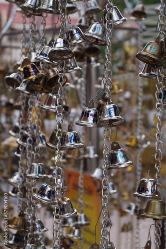 Many small bells and blue skies,Bell in chains against blue sky,Hanging bells and blue skies