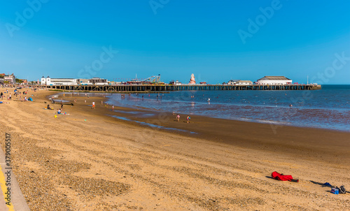 A view along the beach at Clacton on Sea, UK in summertime photo