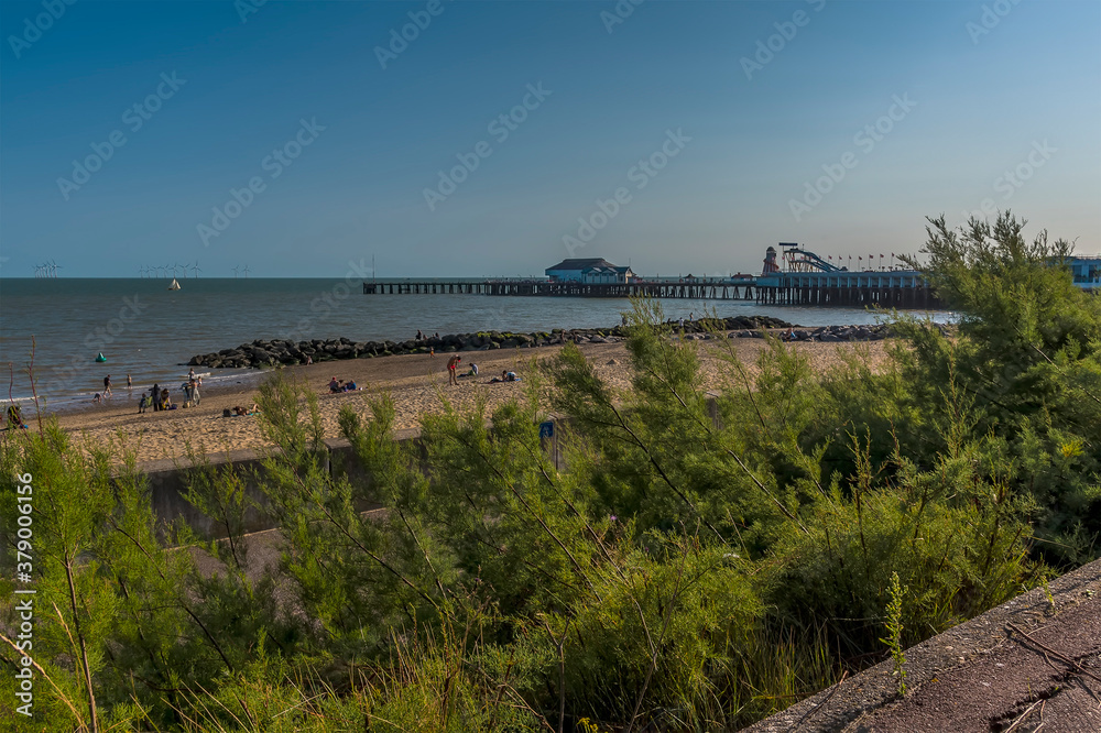 An early evening view from the cliff path along the beach at Clacton on Sea, UK in the summertime