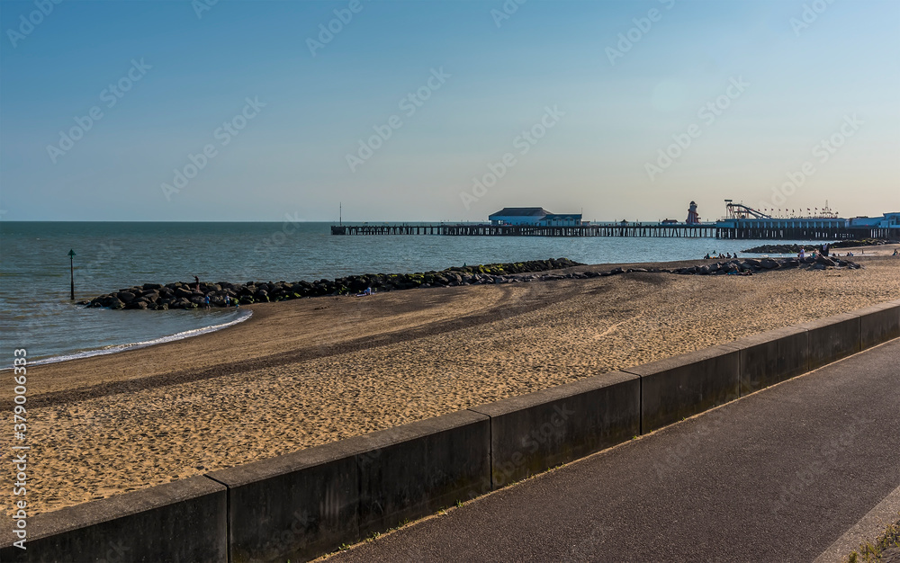An early evening view from the promenade along the beach at Clacton on Sea, UK in the summertime