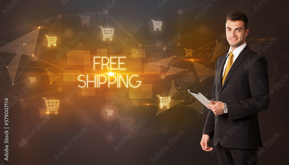 Businessman with shopping cart icons and FREE SHIPPING inscription, online shopping concept Businessman with shopping cart icons and FREE SHIPPING inscription, online shopping concept