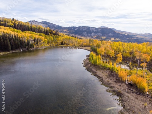 Beautiful lake with yellow autumn leaves in the Rocky Mountains