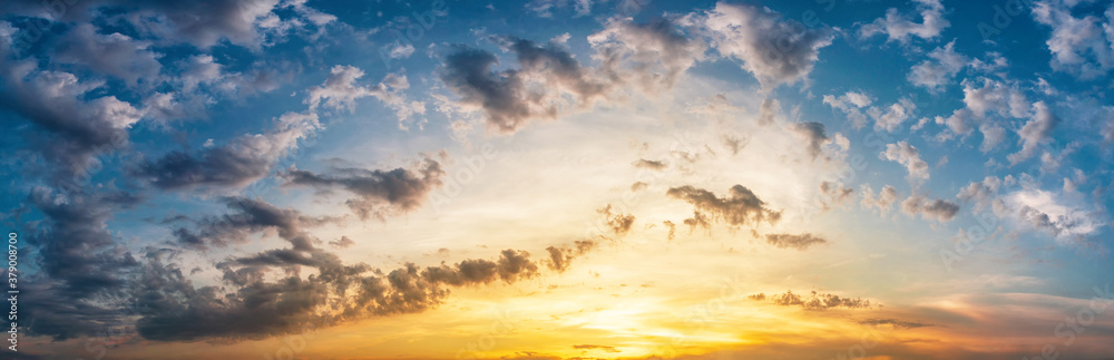 Panorama of dramatic sky with clouds at yellow-orange sunset. Panorama of dramatic sky with clouds at yellow-orange sunset.