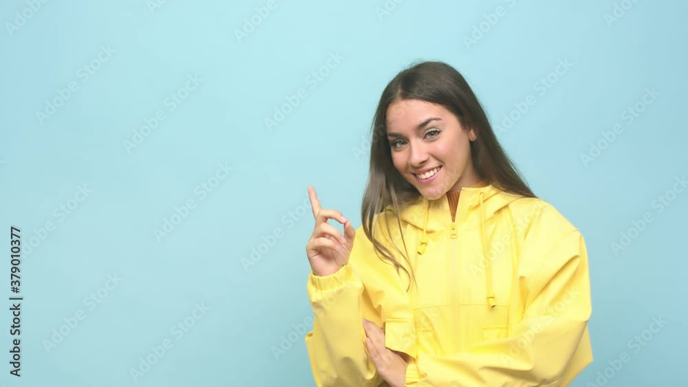 Young cute woman smiling cheerfully pointing with forefinger away Young cute woman smiling cheerfully pointing with forefinger away