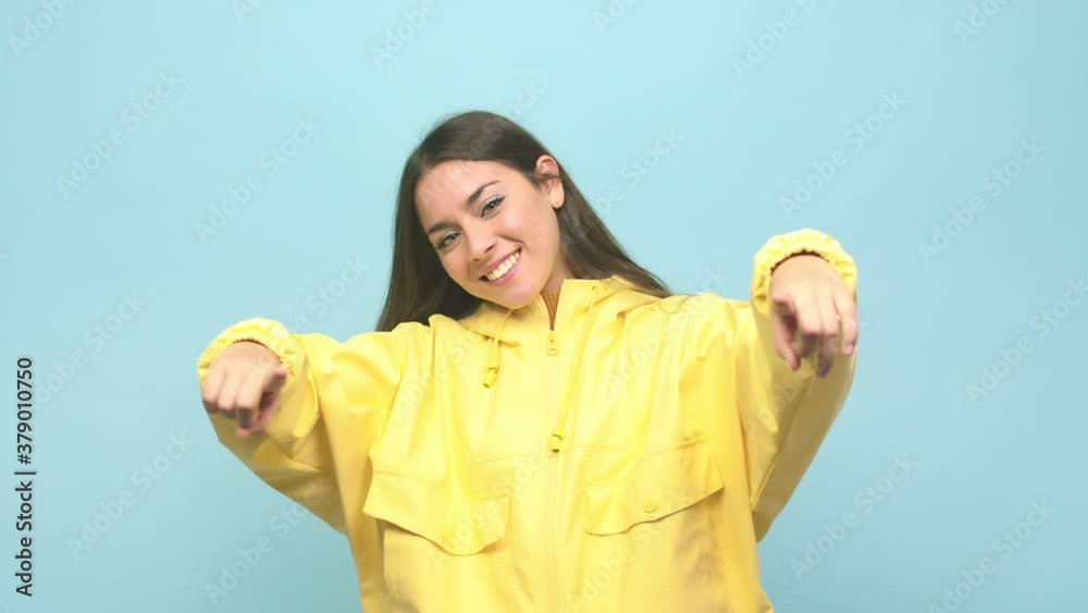 Young cute woman cheerful smiles pointing to front Young cute woman cheerful smiles pointing to front