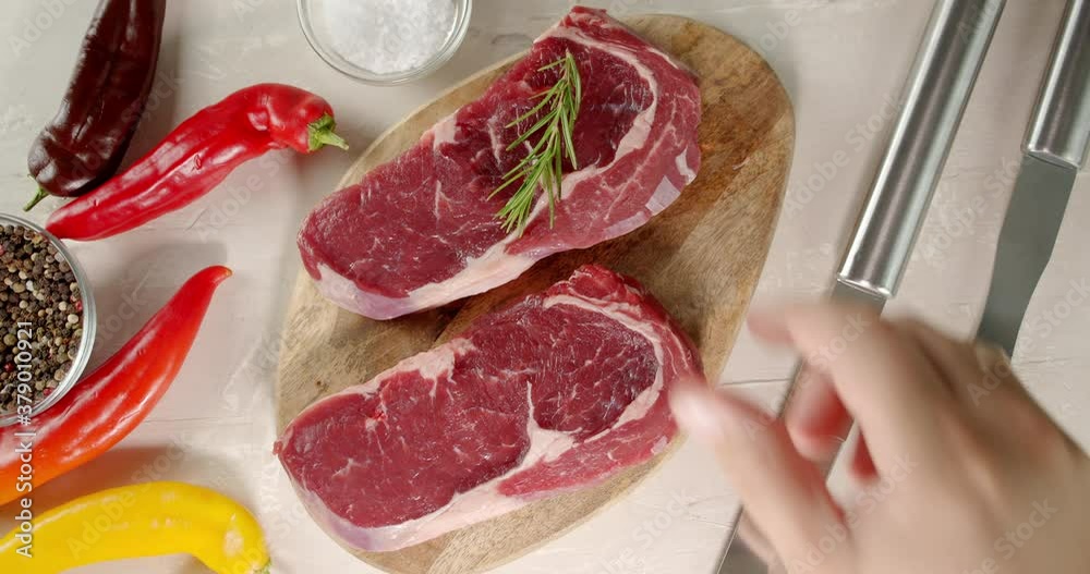 Steaks raw beef ribeye on a wooden cutting board. Steaks raw beef ribeye on a wooden cutting board.
