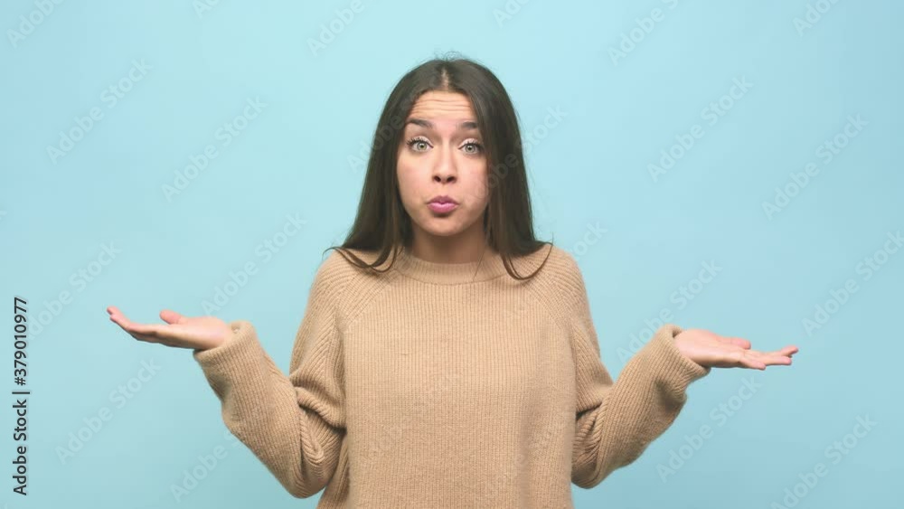 Young cute woman confused and doubtful shrugging shoulders to hold a copy space Young cute woman confused and doubtful shrugging shoulders to hold a copy space