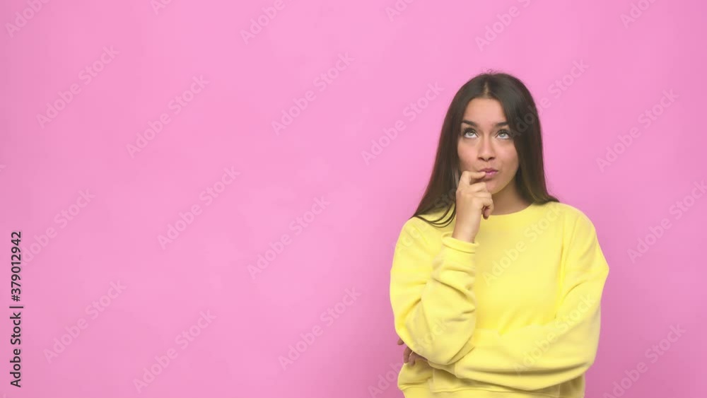 Young cute woman looking sideways with doubtful and skeptical expression Young cute woman looking sideways with doubtful and skeptical expression
