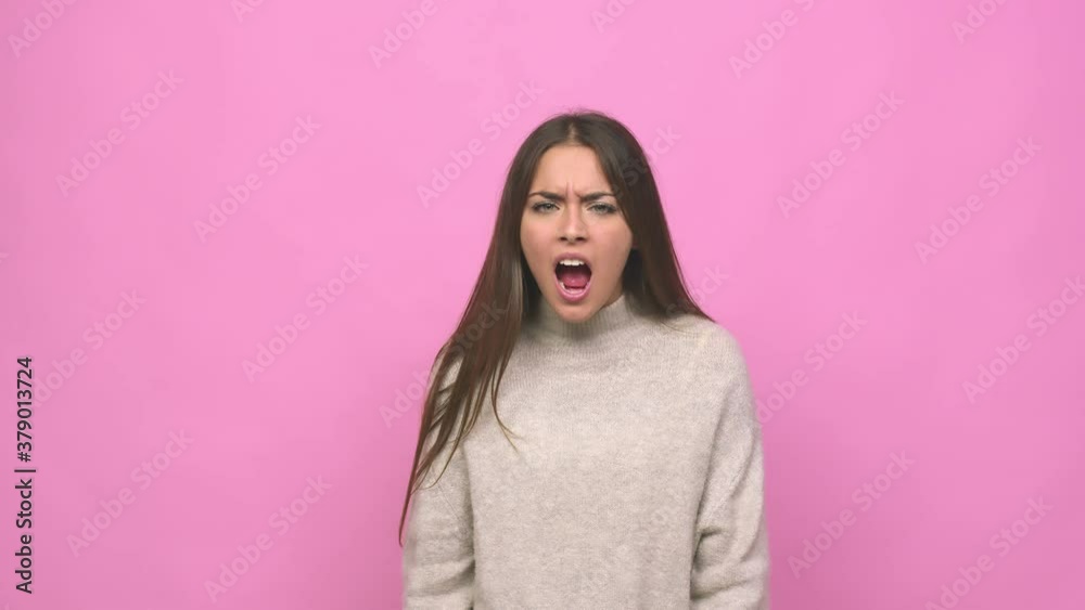 Young cute woman screaming very angry and aggressive Young cute woman screaming very angry and aggressive