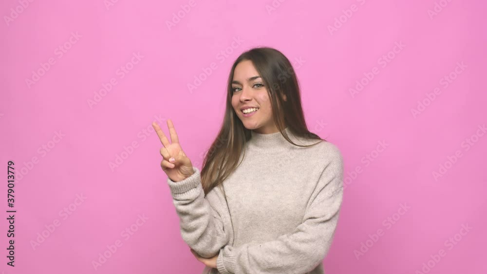 Young cute woman showing number two with fingers Young cute woman showing number two with fingers