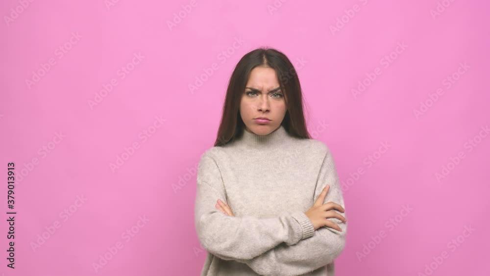 Young cute woman unhappy looking in camera with sarcastic expression Young cute woman unhappy looking in camera with sarcastic expression