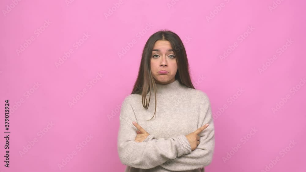 Young cute woman points sideways, is trying to choose between two options Young cute woman points sideways, is trying to choose between two options