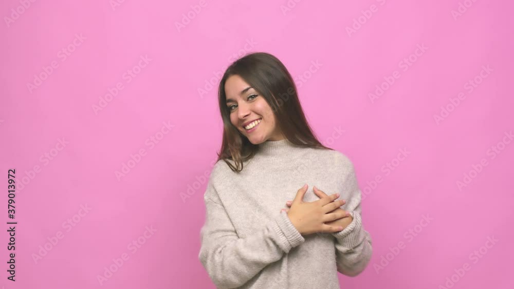 Young cute woman laughing keeping hands on heart, concept of happiness Young cute woman laughing keeping hands on heart, concept of happiness
