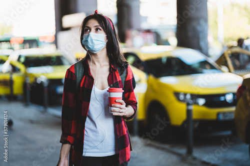 Beautiful young woman waiting at taxi station