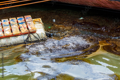 Ecological catastrophy. Close-up. Spill of oil products into the sea.