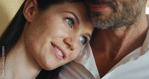 Authentic shot of happy lovely smiling married elegantly dressed couple is enjoying time together and embracing as sign of timeless love at home before going out for romantic dinner at night.