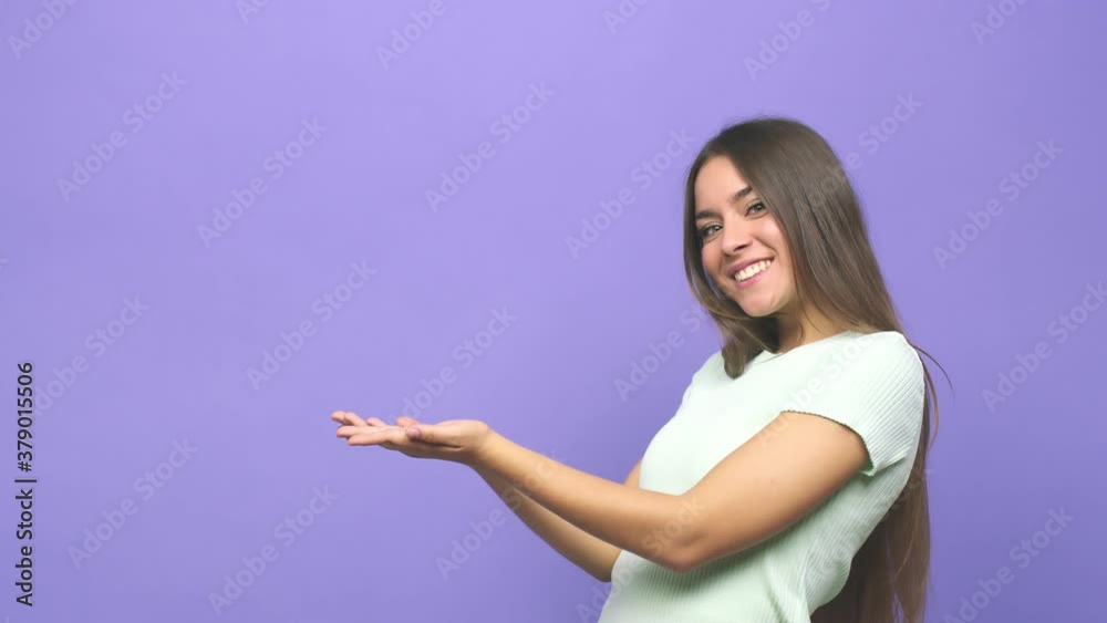 Young cute woman holding a copy space on a palm Young cute woman holding a copy space on a palm