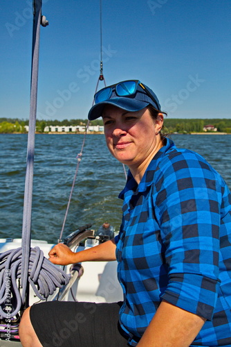 Portrait of a young yachtswoman driving a yacht