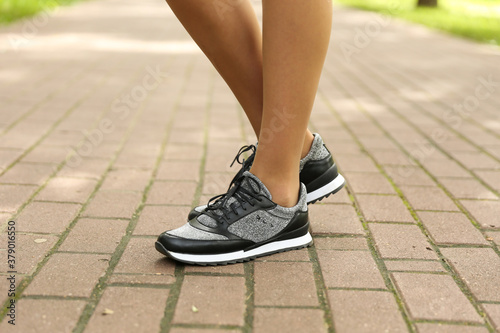 woman's legs in sport sneakers outdoor close up © Петр Смагин
